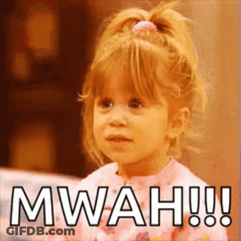 A Little Girl With A Ponytail Is Making A Funny Face And Saying Mwah ! GIF
