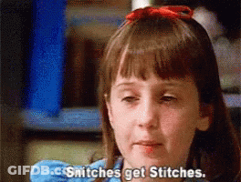 A Little Girl With A Red Bow In Her Hair Is Saying Snitches Get Stitches GIF