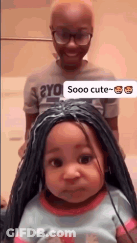 A Little Girl With A Wig On Her Head Is Standing Next To A Man . GIF