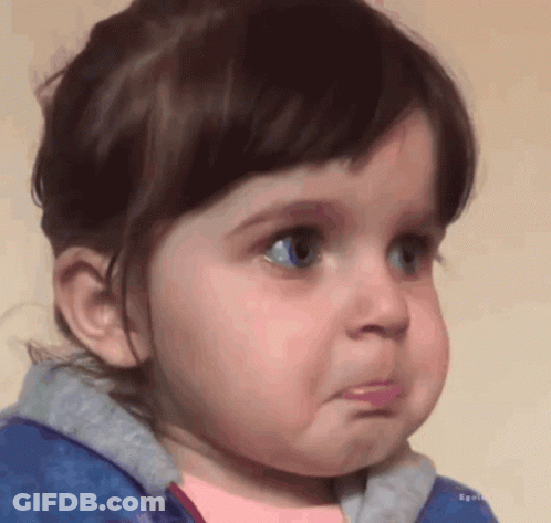 A Little Girl With Blue Eyes Is Making A Sad Face GIF