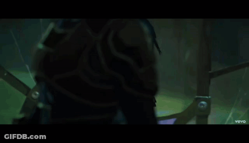 A Little Girl With Blue Hair Is Standing In A Dark Room With A Vevo Logo On The Bottom GIF