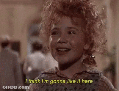 A Little Girl With Curly Hair Is Smiling And Saying I Think I 'M Gonna Like It Here . GIF