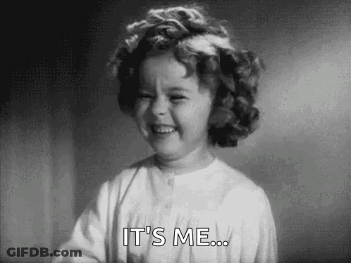 A Little Girl With Curly Hair Is Smiling And Saying `` It 'S Me '' . GIF