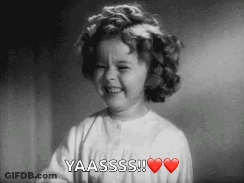 A Little Girl With Curly Hair Is Smiling And Saying Yaasss ! GIF