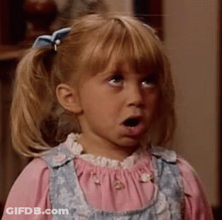 A Little Girl With Pigtails And A Bow On Her Hair Looks Surprised GIF