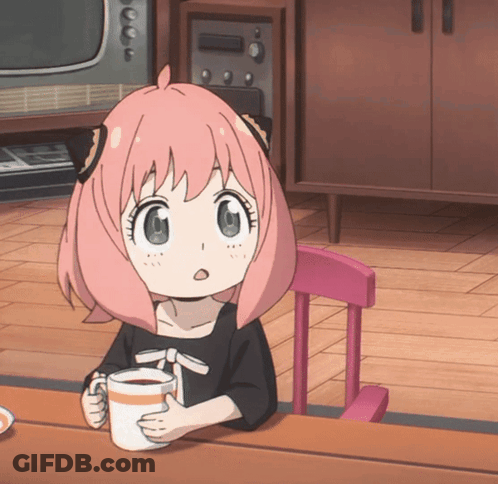 A Little Girl With Pink Hair Is Sitting At A Table With A Cup Of Coffee GIF