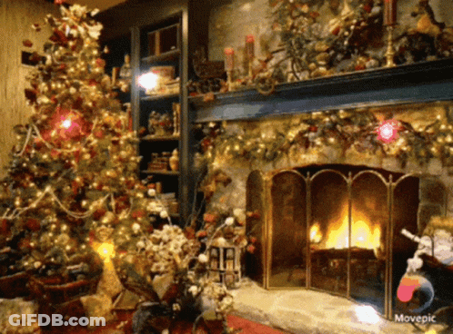 A Living Room Decorated For Christmas With A Christmas Tree And Fireplace GIF