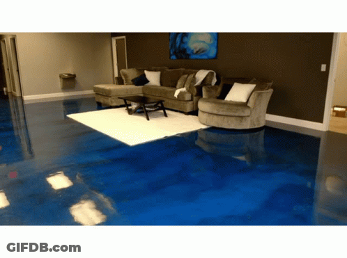 A Living Room With A Blue Floor And Couch GIF
