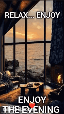 A Living Room With A Fireplace And A Large Window Overlooking The Ocean With The Words `` Relax ... Enjoy The Evening '' GIF