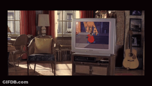 A Living Room With A Philips TV On The Entertainment Center GIF