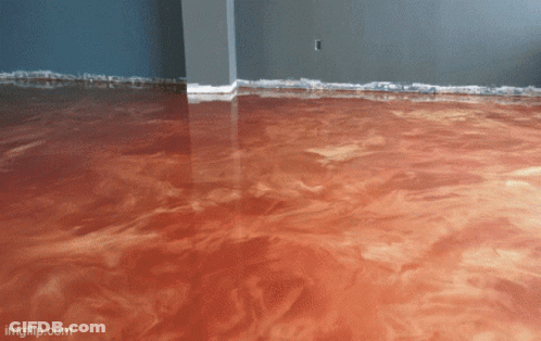 A Living Room With Blue Floors And A Couch And Chair GIF
