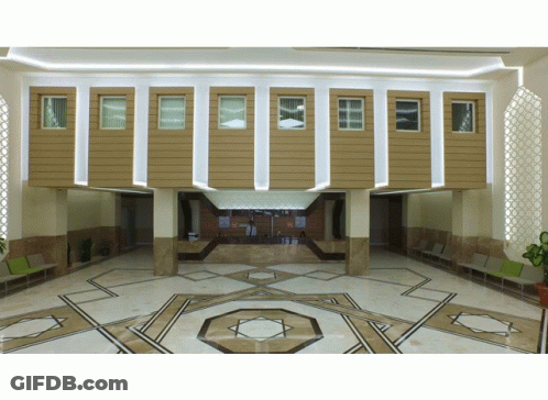 A Lobby With A Geometric Pattern On The Floor And A Counter GIF
