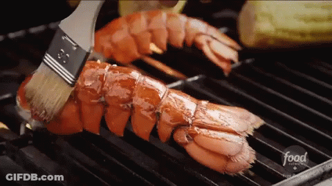 A Lobster Is Being Cooked On A Grill With A Brush And The Word Food Is On The Bottom GIF