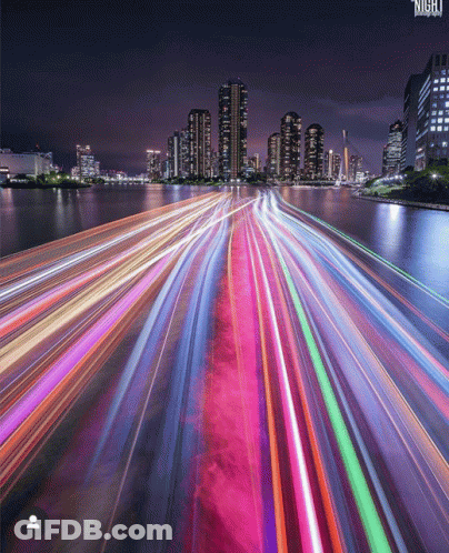 A Long Exposure Photo Of A City At Night With The Word Night On The Bottom GIF