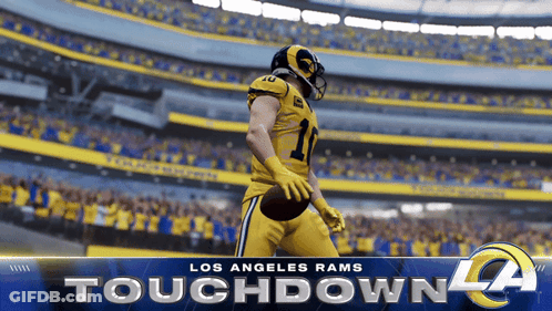 A Los Angeles Rams Football Player Is Holding A Football GIF