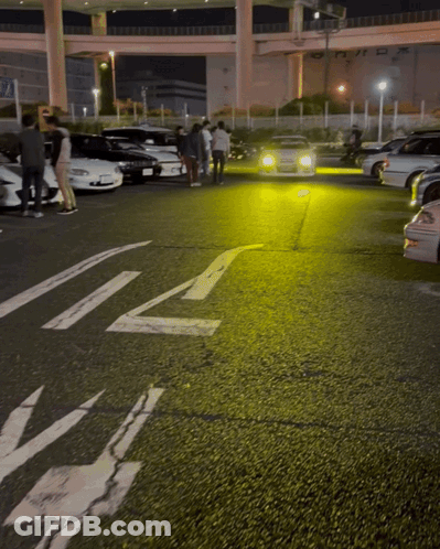A Lot Of Cars Are Parked In A Parking Lot With A White Arrow Pointing To The Right GIF