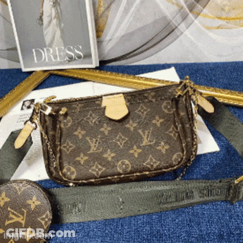 A Louis Vuitton Purse Is Sitting On A Blue Table GIF