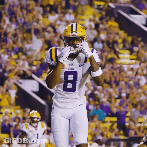 A Lsu Football Player Wearing A White Jersey With The Number 8 On It GIF