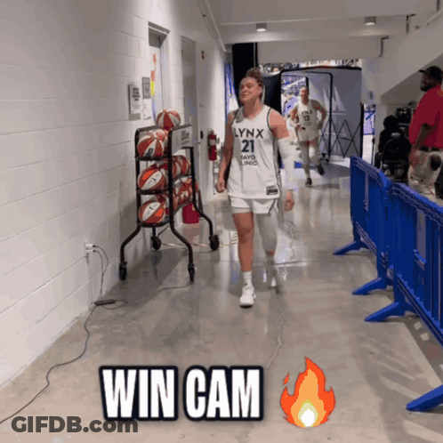 A Lynx Basketball Player Walks Down The Hallway GIF