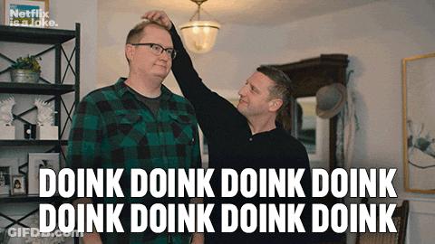 A Man Adjusts Another Man 'S Head With A Caption That Says Doink Doink Doink Doink Doink Doink Doink GIF