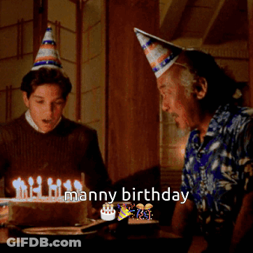 A Man And A Boy Are Celebrating A Man 'S Birthday With Candles On A Cake GIF