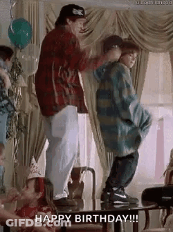 A Man And A Boy Are Dancing At A Birthday Party In A Living Room . GIF