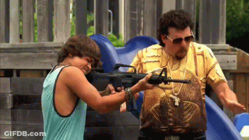 A Man And A Boy Are Playing With A Gun At A Playground GIF