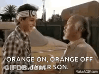 A Man And A Boy Are Shaking Hands In Front Of A Car And A Building . GIF