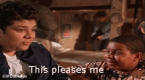 A Man And A Boy Are Sitting Next To Each Other In A Room And The Boy Is Saying This Pleases Me . GIF