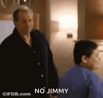 A Man And A Boy Are Standing Next To Each Other In A Room And The Man Is Talking To The Boy . GIF