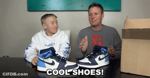 A Man And A Boy Sit At A Table With A Pair Of Cool Shoes GIF