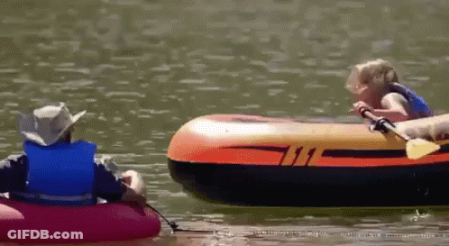 A Man And A Child Are In A Raft On A Lake GIF