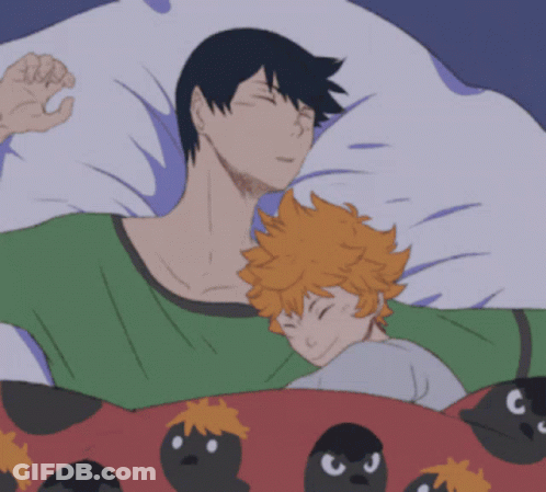 A Man And A Child Are Sleeping In A Bed With Birds On The Blanket GIF