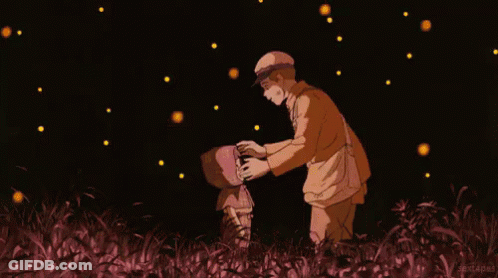 A Man And A Child Are Standing In A Field With Fireflies Flying Around Them GIF