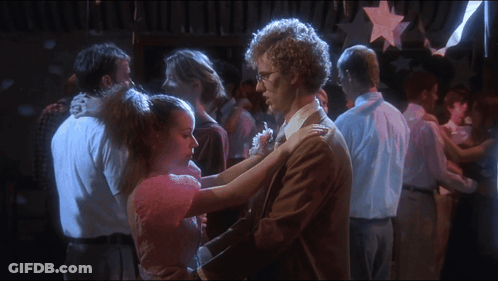 A Man And A Girl Are Dancing In A Crowded Room GIF