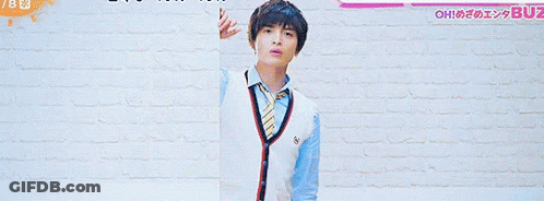 A Man And A Girl Are Standing In Front Of A Brick Wall With The Number 7 On The Bottom GIF