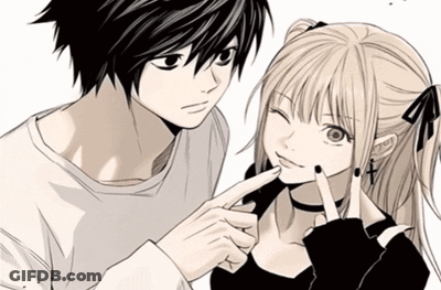 A Man And A Girl Are Standing Next To Each Other And The Girl Is Pointing At The Man 'S Face GIF
