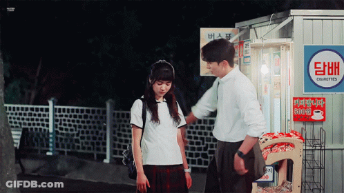 A Man And A Girl Standing In Front Of A Cigarette Vending Machine GIF
