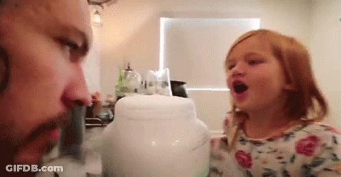 A Man And A Little Girl Are Playing With A Jar . GIF