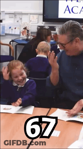 A Man And A Little Girl Are Sitting At A Table With The Number 67 On The Bottom GIF