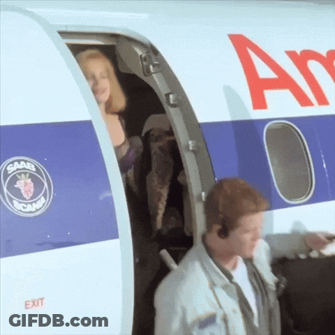 A Man And A Woman Are Boarding An Airplane That Says Saab On The Side GIF