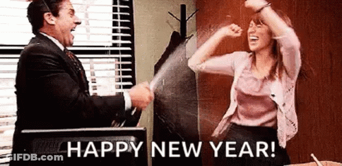 A Man And A Woman Are Celebrating A New Year . GIF