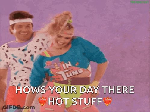 A Man And A Woman Are Dancing And The Woman Is Wearing A Shirt That Says In Tune . GIF