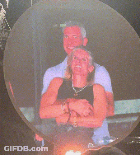 A Man And A Woman Are Dancing In A Club GIF