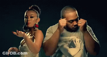 A Man And A Woman Are Dancing In A Dark Room GIF