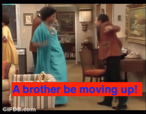 A Man And A Woman Are Dancing In A Living Room With The Words " A Brother Be Moving Up " GIF