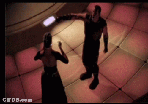 A Man And A Woman Are Dancing In A Room GIF