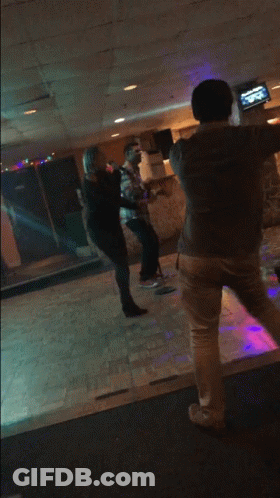 Man And Woman Dancing In Purple Lighted Room GIF