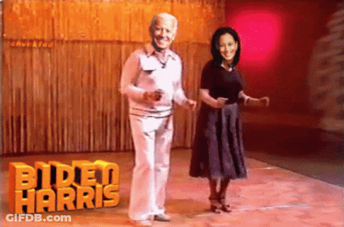 Dancing Couple In Front Of Biden Harris Logo GIF