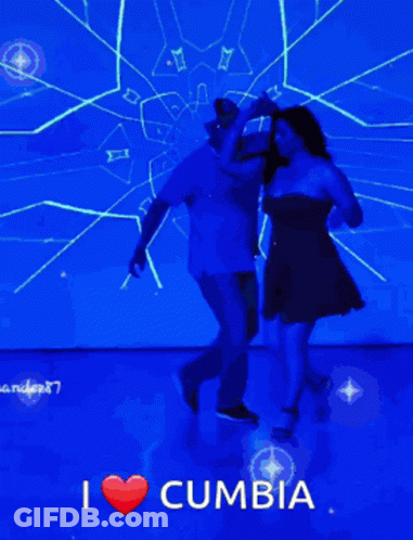 A Man And A Woman Are Dancing In Front Of A Blue Screen That Says I Love Cumbia GIF